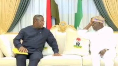 Sierra Leone's President Julius Bio (L) and President Bola Tinubu of Nigeria (R)